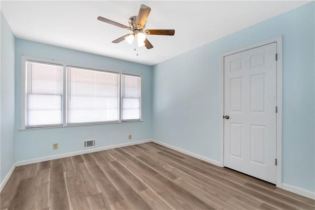 spare room with ceiling fan and light hardwood / wood-style floors