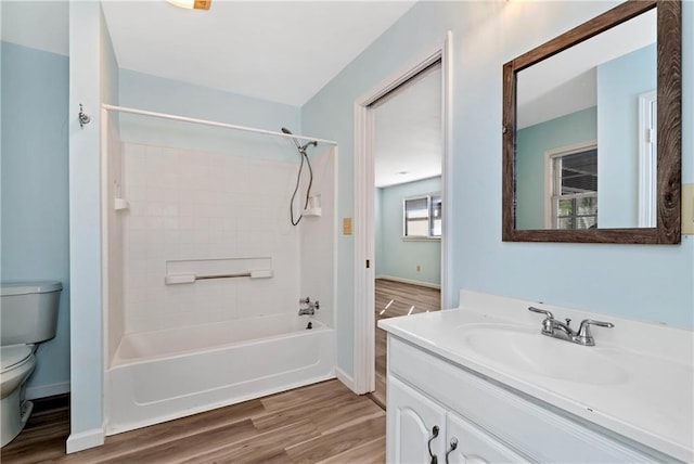 full bathroom with washtub / shower combination, hardwood / wood-style floors, vanity, and toilet