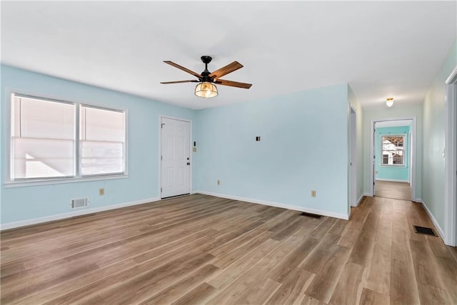 interior space with ceiling fan and light hardwood / wood-style flooring