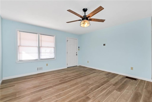 spare room with hardwood / wood-style floors and ceiling fan