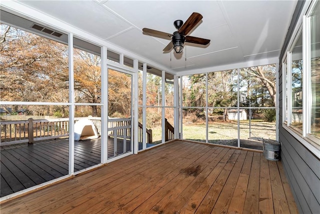 unfurnished sunroom featuring a wealth of natural light and ceiling fan