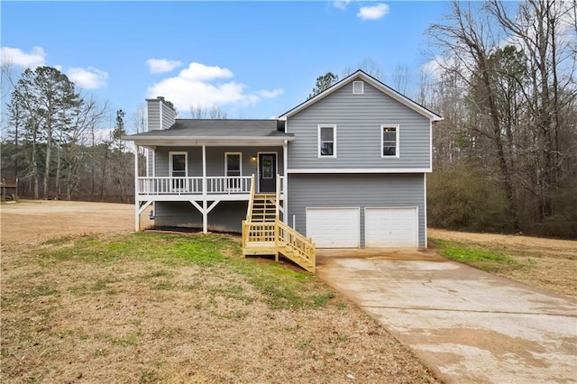 view of front of house featuring a garage, a porch, and a front lawn