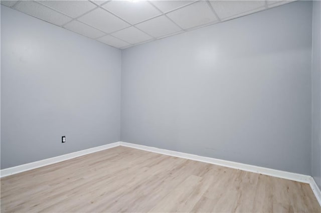 unfurnished room featuring a paneled ceiling and light hardwood / wood-style flooring