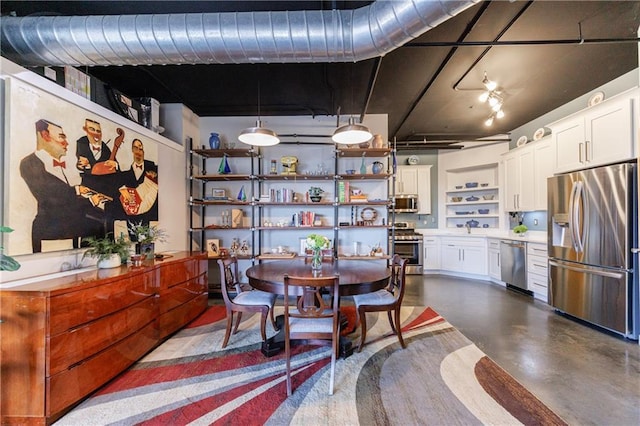 dining space featuring concrete floors