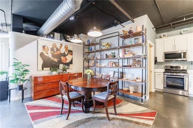 dining area with finished concrete floors