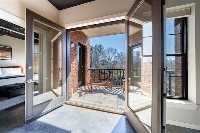 entryway with brick wall and french doors