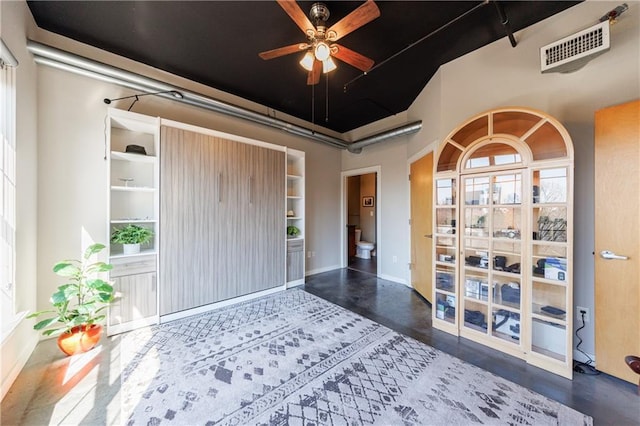 interior space with visible vents and a ceiling fan