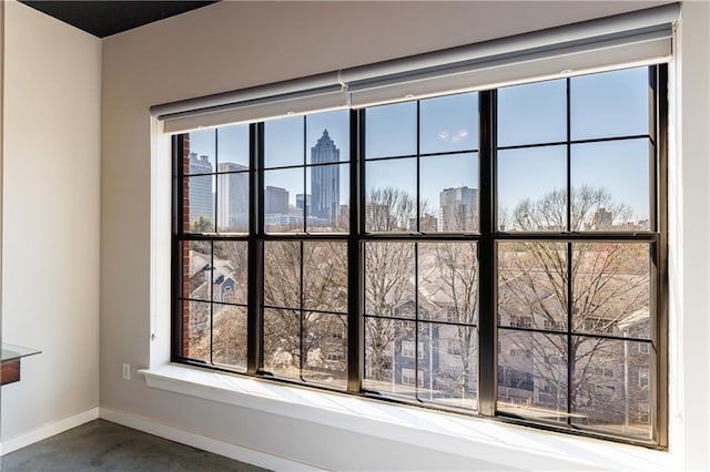 details featuring baseboards, concrete flooring, and a city view