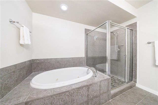 bathroom with a jetted tub, a shower stall, and tile patterned floors