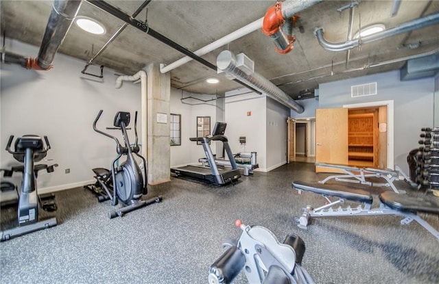 exercise room with visible vents and baseboards