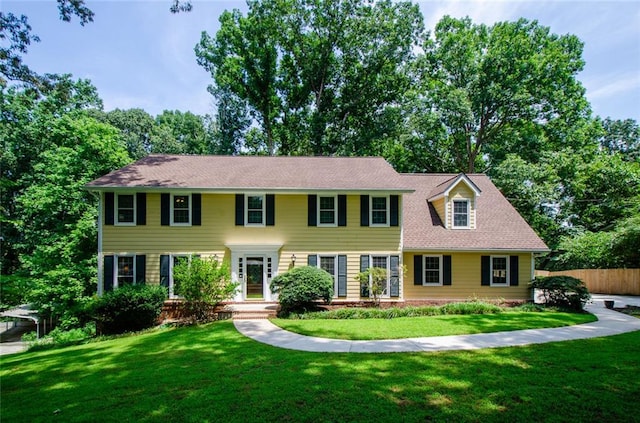 colonial-style house with a front lawn