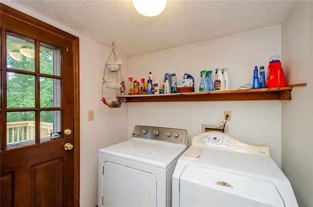 washroom with washer and dryer and a textured ceiling