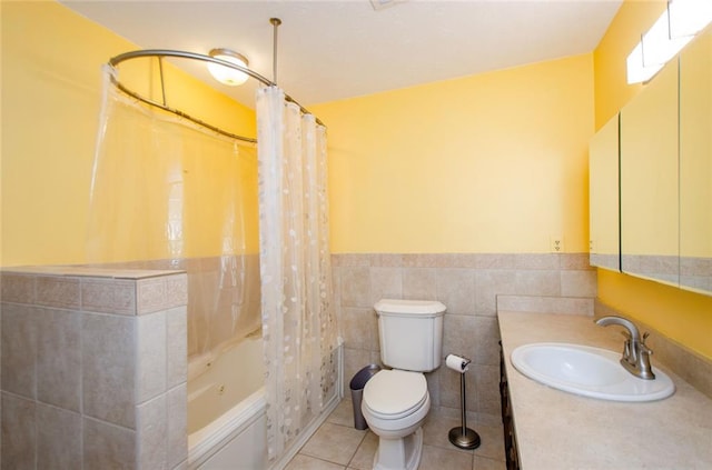 full bathroom with shower / tub combo, tile patterned flooring, tile walls, vanity, and toilet