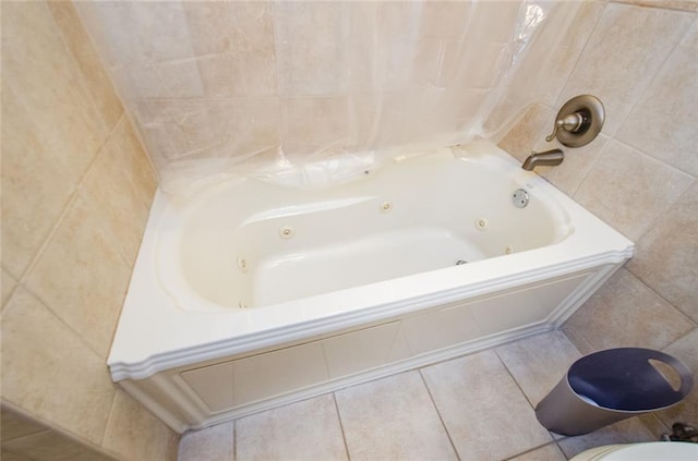 bathroom with tile walls, tile patterned floors, and tiled bath