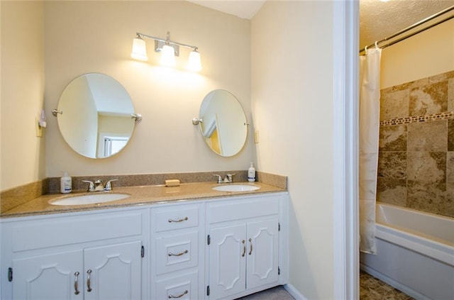 bathroom with shower / tub combo and vanity