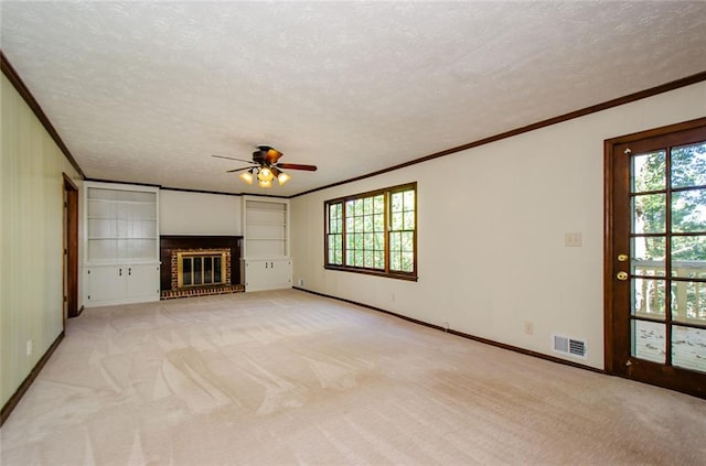 unfurnished living room with light carpet, plenty of natural light, and a textured ceiling