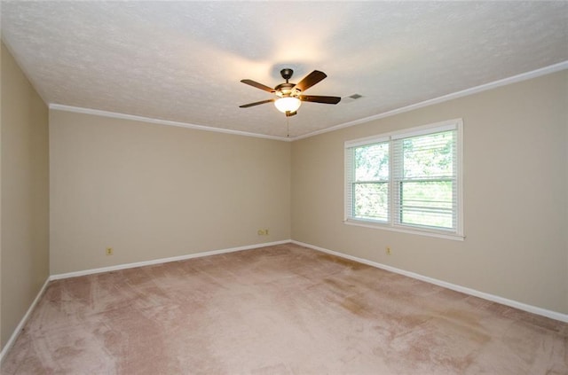 carpeted spare room with ornamental molding, ceiling fan, and a textured ceiling