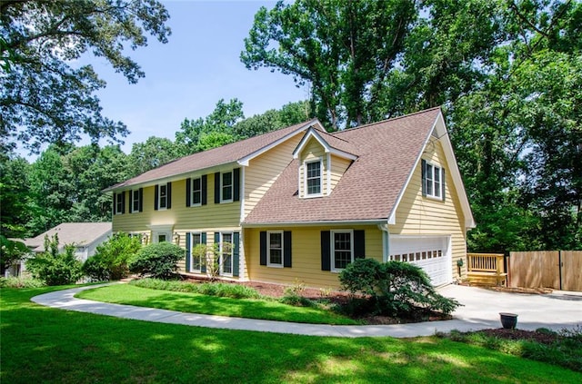 view of front of property with a garage and a front lawn