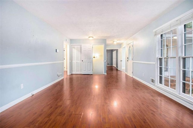 spare room featuring dark wood-type flooring