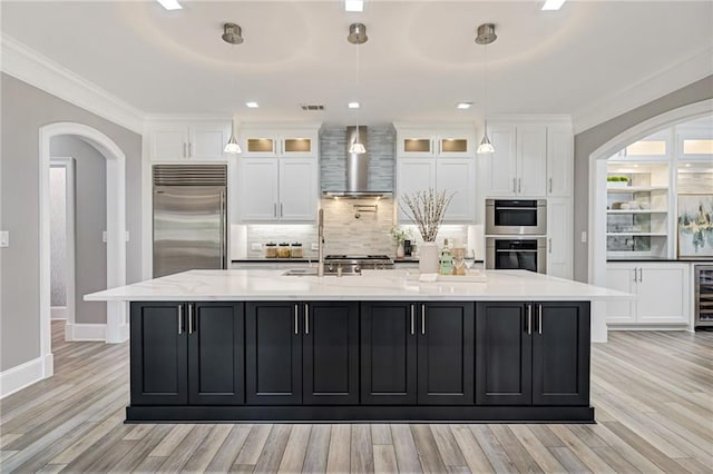 2444 Ballantrae Cir, Cumming, GA 30041 - kitchen with wall chimney range hood, crown molding, appliances with stainless steel finishes, a sink, and decorative backsplash