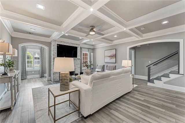 2444 Ballantrae Cir, Cumming, GA 30041 - living room with arched walkways, baseboards, beamed ceiling, and light wood-style flooring