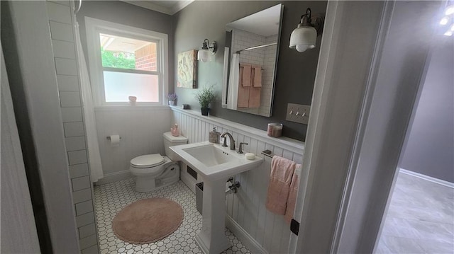 2132 Clairmont Rd, Brookhaven, GA 30033 - full bathroom featuring toilet, a wainscoted wall, tile patterned floors, a shower, and ornamental molding
