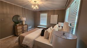 2132 Clairmont Rd, Brookhaven, GA 30033 - bedroom featuring ornamental molding, a notable chandelier, baseboards, and multiple windows
