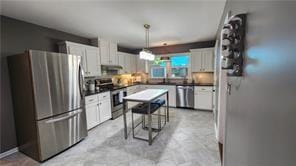 2132 Clairmont Rd, Brookhaven, GA 30033 - kitchen with white cabinets, dark countertops, and appliances with stainless steel finishes
