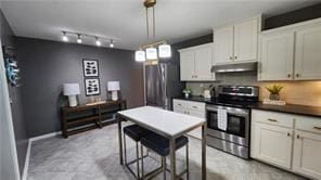 2132 Clairmont Rd, Brookhaven, GA 30033 - kitchen with dark countertops, white cabinets, appliances with stainless steel finishes, and under cabinet range hood