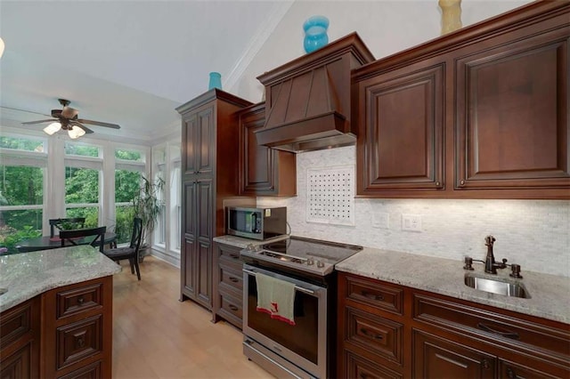 825 Chalet Hls, Mcdonough, GA 30253 - kitchen featuring stainless steel appliances, ceiling fan, tasteful backsplash, premium range hood, and light stone countertops