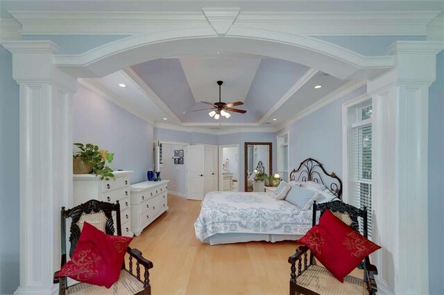 825 Chalet Hls, Mcdonough, GA 30253 - bedroom featuring arched walkways, ornate columns, light wood-style floors, a tray ceiling, and ornamental molding