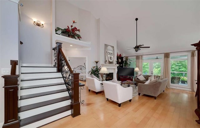 825 Chalet Hls, Mcdonough, GA 30253 - living area featuring ceiling fan, high vaulted ceiling, stairway, light wood finished floors, and a fireplace