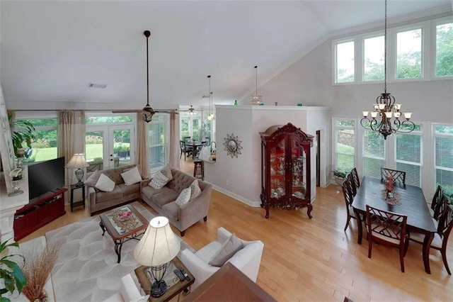 825 Chalet Hls, Mcdonough, GA 30253 - living room featuring a chandelier, light wood-type flooring, french doors, and high vaulted ceiling