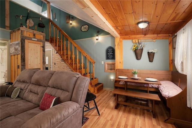 living room featuring stairs, wood finished floors, and wood ceiling