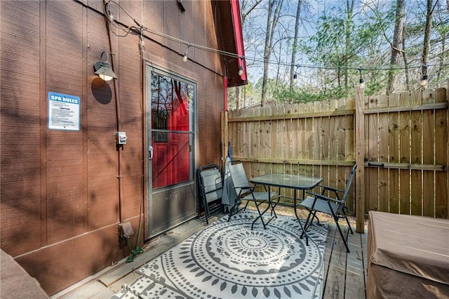 view of patio / terrace featuring fence