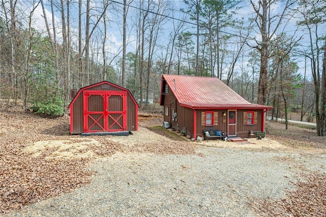 view of shed with a wooded view