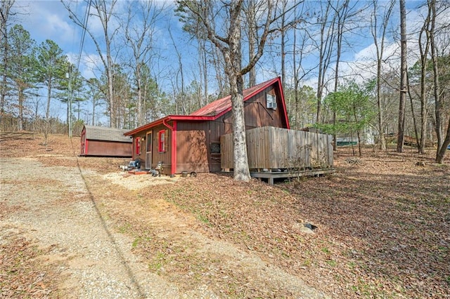 view of side of home featuring an outbuilding