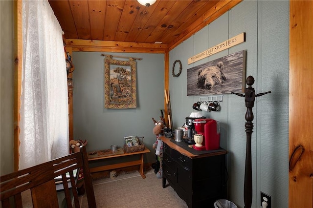 hall with wood ceiling and light colored carpet