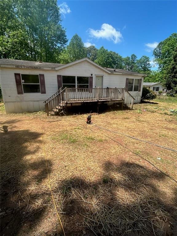 rear view of house with a wooden deck