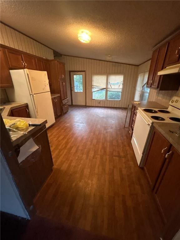 kitchen with a textured ceiling, light countertops, dark wood-style floors, under cabinet range hood, and white appliances
