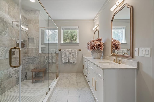 full bathroom with ornamental molding, marble finish floor, a shower stall, and vanity