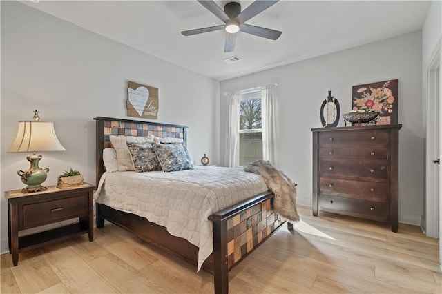 bedroom with ceiling fan, visible vents, and light wood-style floors