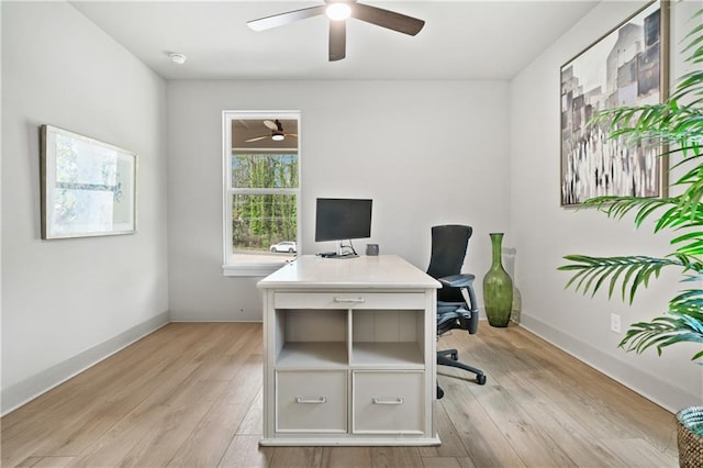 office area with light wood-style flooring, baseboards, and a ceiling fan