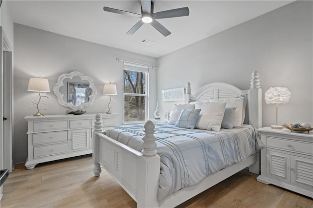 bedroom featuring visible vents, ceiling fan, and light wood-style flooring