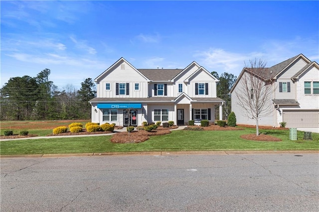 view of front of property with a front lawn and a garage