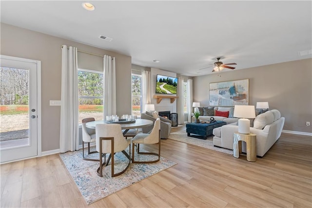 dining space featuring light wood-type flooring and ceiling fan