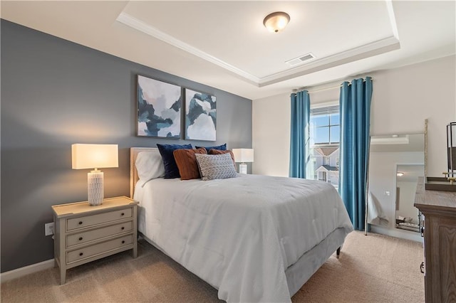 bedroom featuring a tray ceiling and light colored carpet