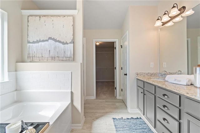 bathroom with vanity and a tub