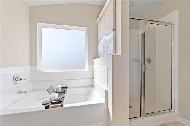 bathroom with lofted ceiling and plus walk in shower