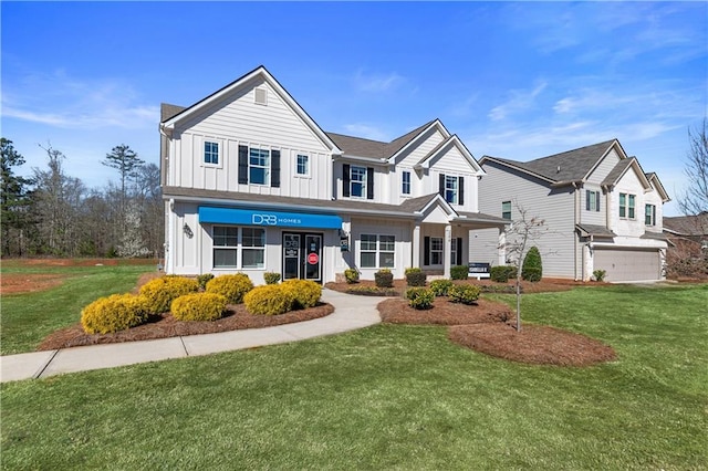 view of front facade with a garage and a front lawn